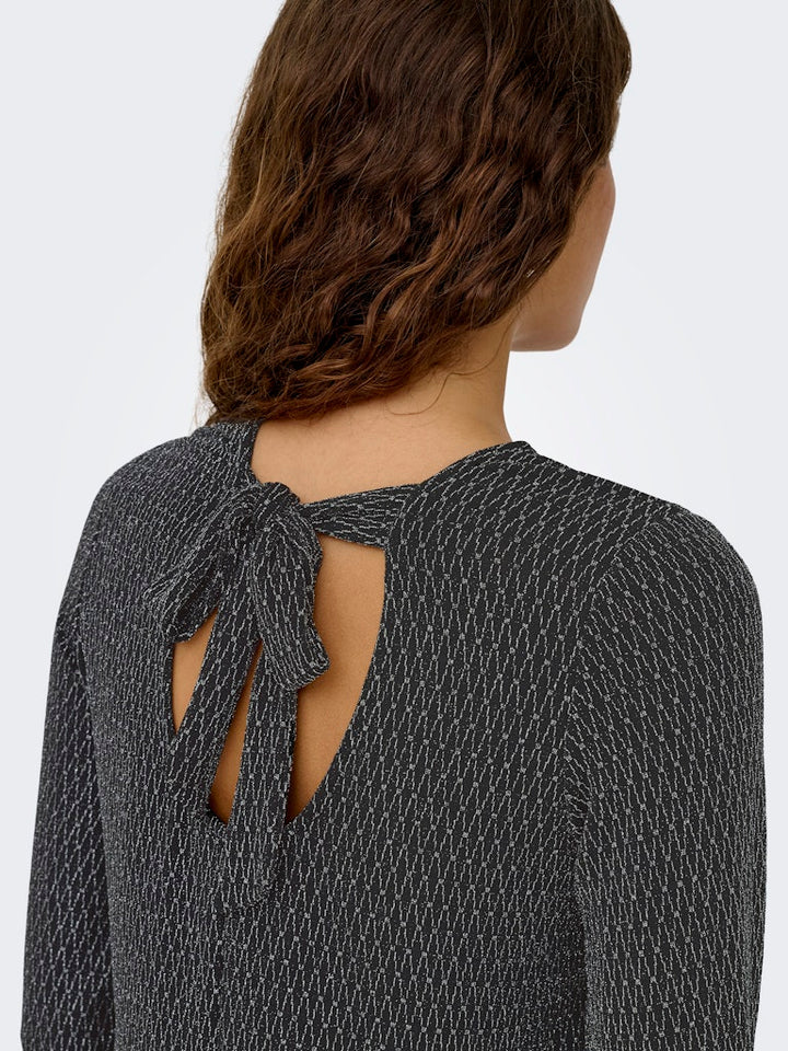 Only ONLCAROL L/S GLITTER BOW TOP BOX JRS – dames blouse - Zwart Dessin